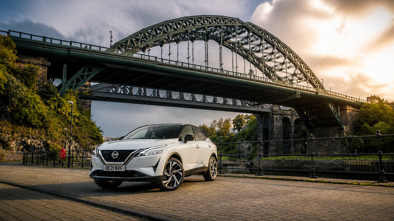 White Nissan SUV parked on cobblestone near a large steel arch bridge at sunset with cloudy sky.
